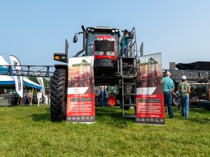 Large farm equipment with Agriteer signs against them